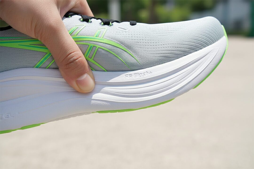 GEL-NIMBUS 28のミッドソールを指で押し込みクッション性の高さを示す様子